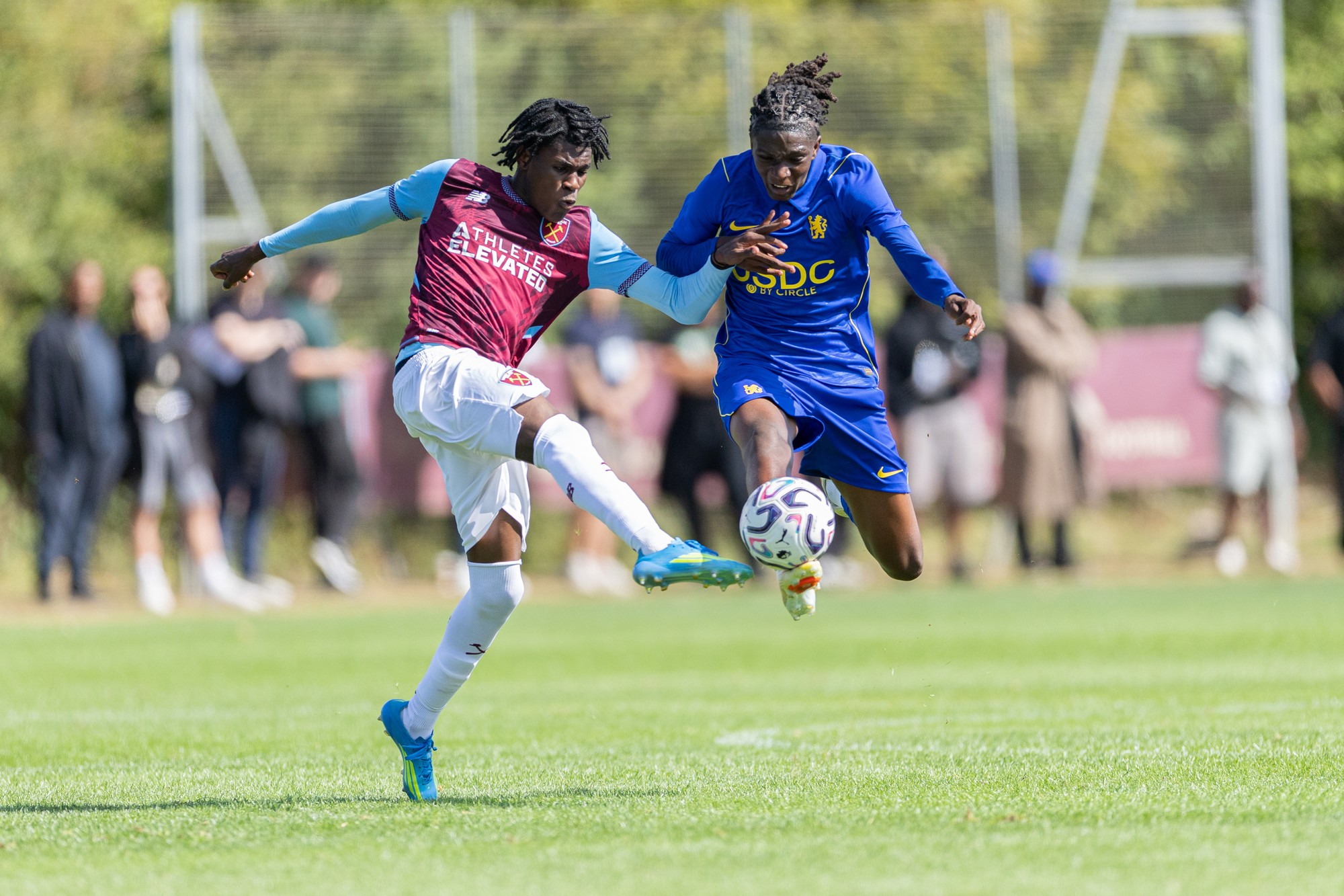 Chelsea and West Ham players challenging for a high ball