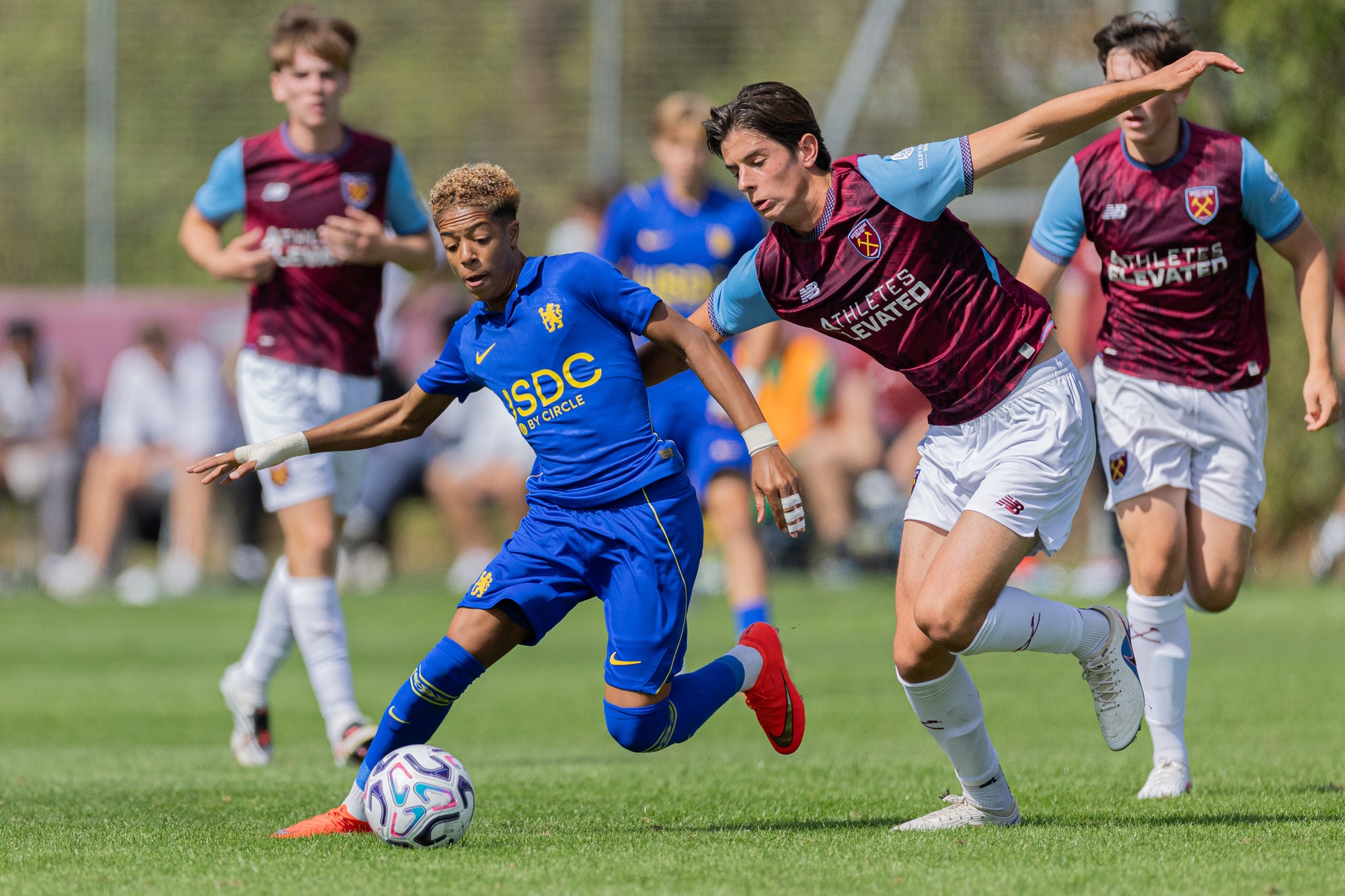 Chelsea forward holding off two West Ham defenders