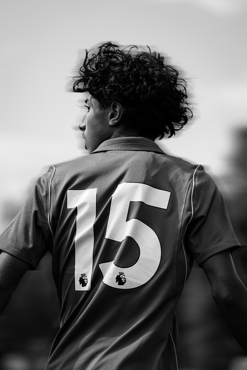 Player wearing number 15 seen from behind, black and white, motion blur edit