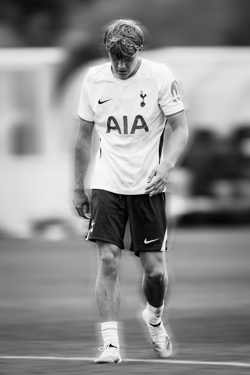 Tottenham player walking, black and white, motion blur edit