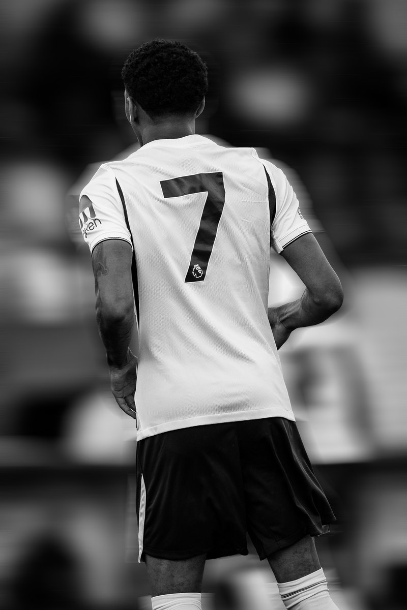 Tottenham player wearing number 7 seen from behind, black and white, motion blur edit