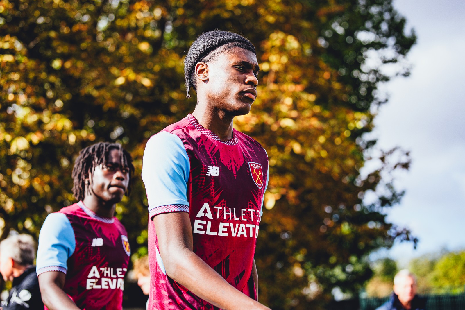 West Ham U18 player walking out, autumn trees behind