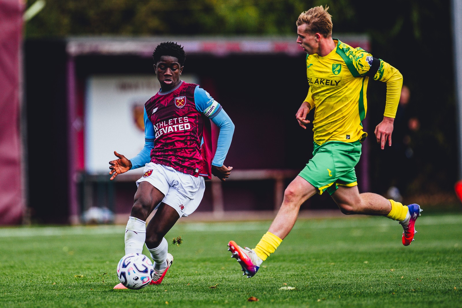 West Ham U18 player on the ball, chased by a Norwich player