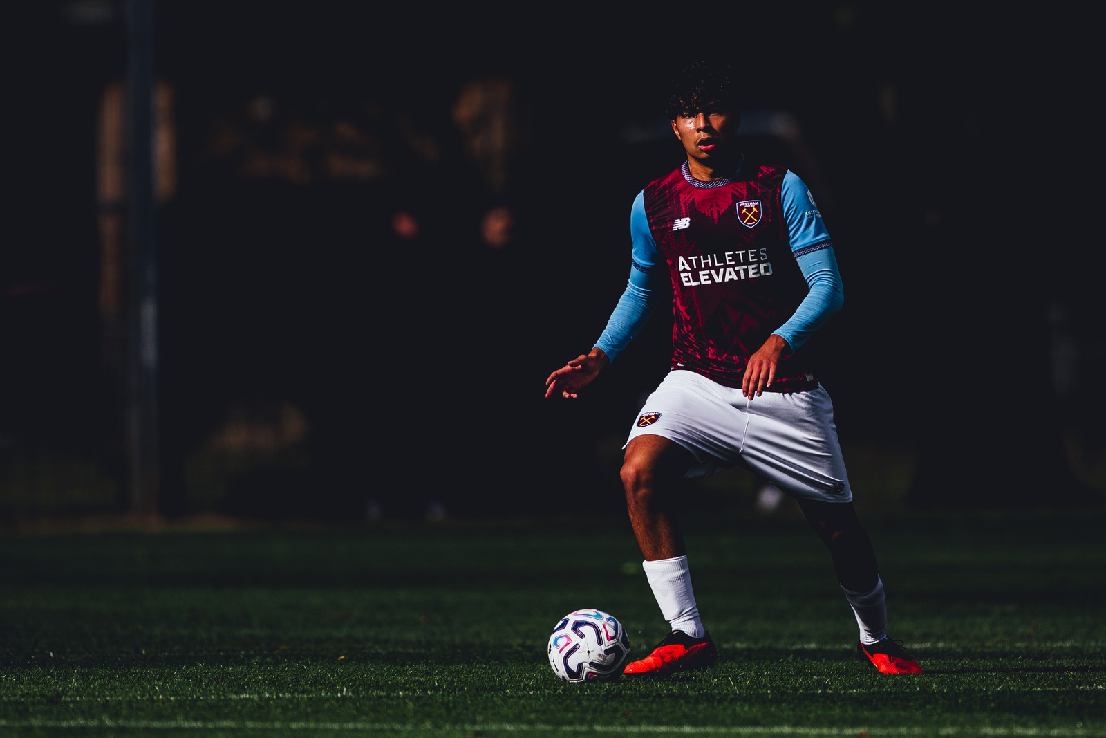 West Ham U18 player on the ball against a dark background